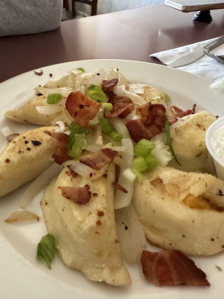 Perogies sautéed with bacon and onions, served with sour cream