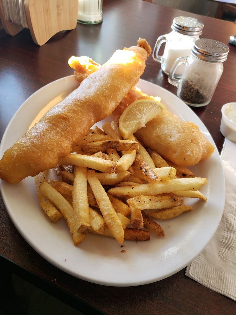Hand-battered fish & chips with a lemon wedge