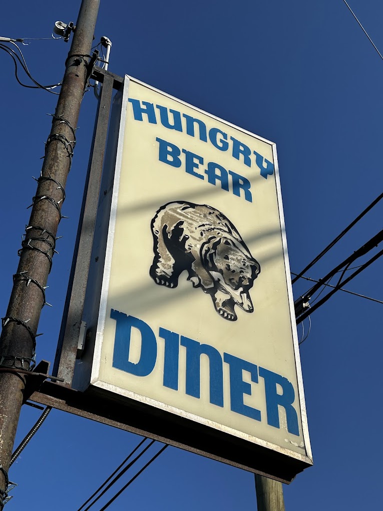 The Hungry Bear Diner sign in Lac la Hache against a clear blue sky