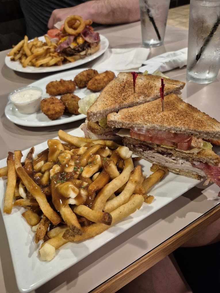 Bacon cheeseburger with onion rings, a bowl of soup, and a Molson Canadian