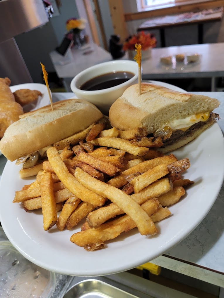 Beef dipper sandwich with hand-cut fries and a side of au jus