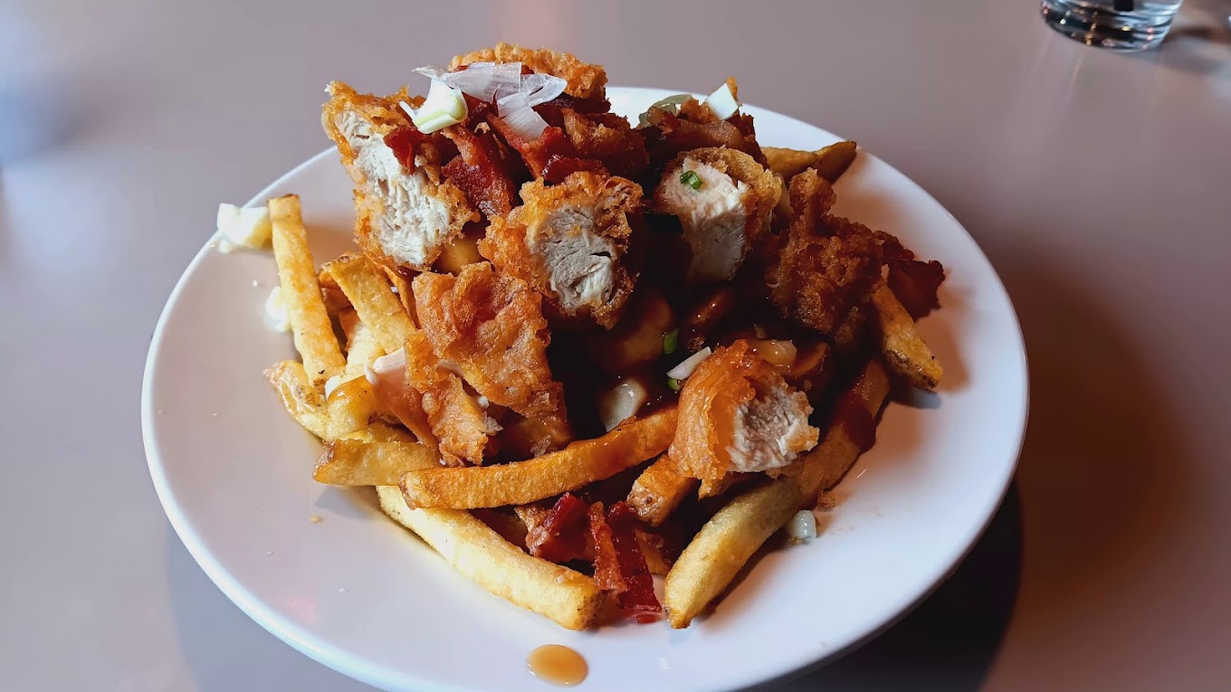 The Hungry Bear Poutine — fries piled with chicken tenders, bacon, gravy, and cheese curds